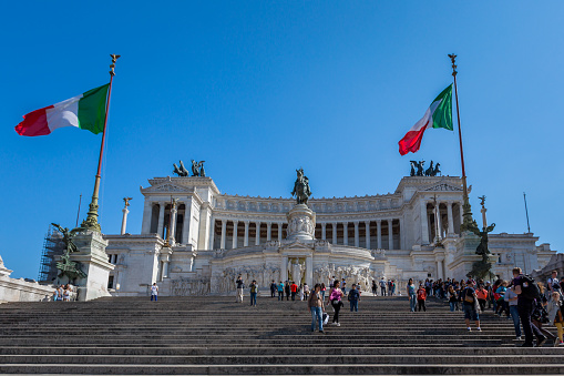 Rome, Italy - April 20, 2015: Low angle view of people on the steps in front of the Vittorio Emanuele II Monument and building in Rome Italy April 20, 2015.