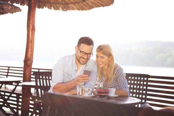 istock A handsome bearded young man shows interesting things on his smart phone 1145834291