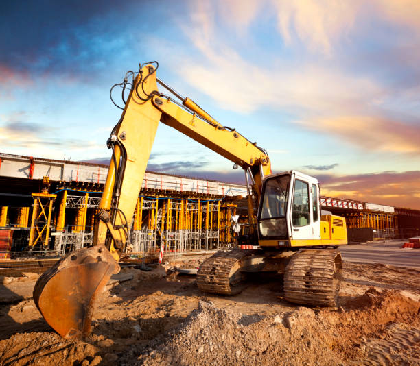 istock Excavator at a construction site against the setting sun 1145834550