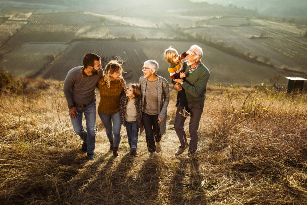 istock Happy multi-generation family talking while taking a walk on the field. 1145835240