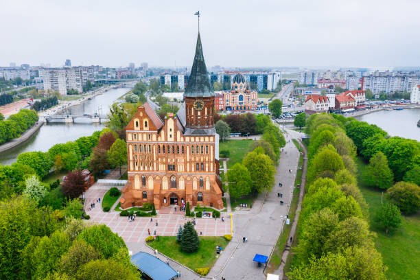 Aerial cityscape of Kant Island in Kaliningrad. Kant cathedral in the centre of the shot. The city's iconic Gothic-style Lutheran cathedral, started in 1333 and completed over the course of the 14th century in the red brick which punctuates so much of Hanseatic architecture, has had to bounce back from some serious setbacks over the centuries. WW2 saw the cathedral more thoroughly destroyed, this time by Allied air raids, and it remained in ruins until 1992 when a huge rebuilding project got underway.
