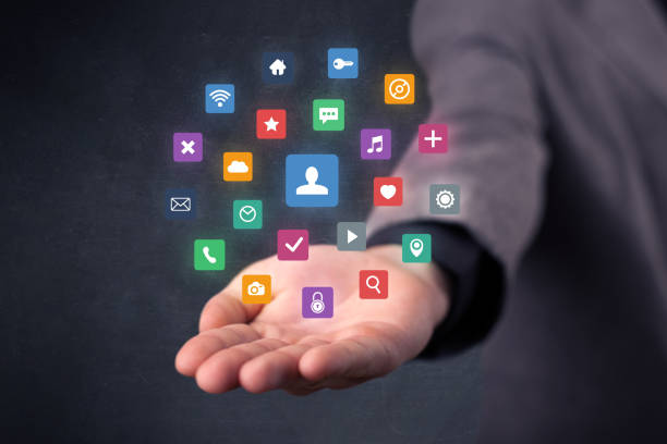 istock Businessman holding colorful applications 1145838083