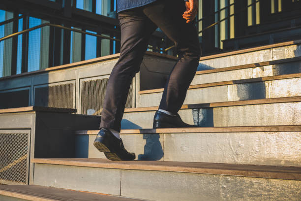 istock Businessman legs walking up the stairs 1145838848