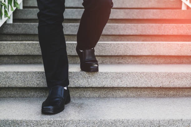istock Businessman legs walking down the stairs 1145839181