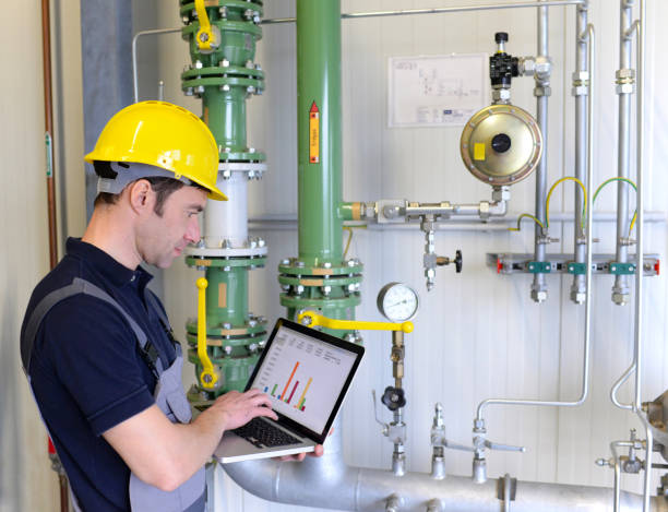istock workers in an industrial plant check the systems with modern technology 1145840423