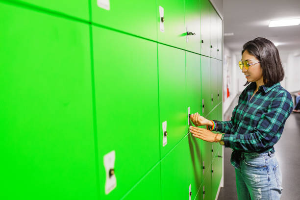 Green automated self service post terminal machine or locker to receive a parcel or to deposit the luggage for storage