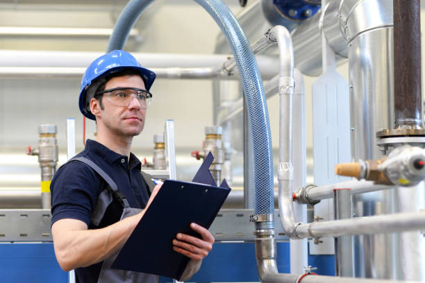 istock industrial workers inspect the technology of a plant for function - assembler in working clothes 1145840510