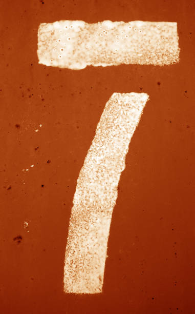 istock Number 7 in stencil on metal wall in orange tone 1145842622