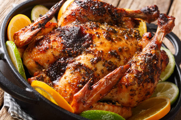 istock Whole baked Cuban chicken marinated with mojo sauce served with oranges and lime close-up in a pan. horizontal 1145843376