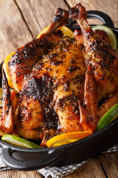 istock Cuban Chicken is infused with a flavorful Mojo marinade made with citrus, garlic and spices close-up in a pan. vertical 1145843473