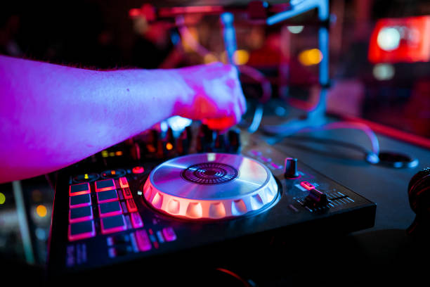 istock DJ mixing music on console at the night club 1145843608