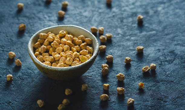 istock Bowl chickpea close up on dark stone background with copy space 1145843892