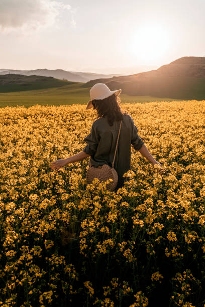 istock Unrecognizable woman walking among flowers 1145845109