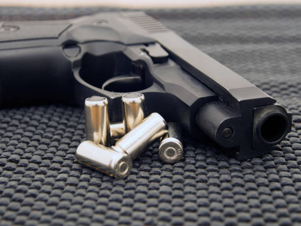 istock Close-up of a pistol with ammunition. 1145845349