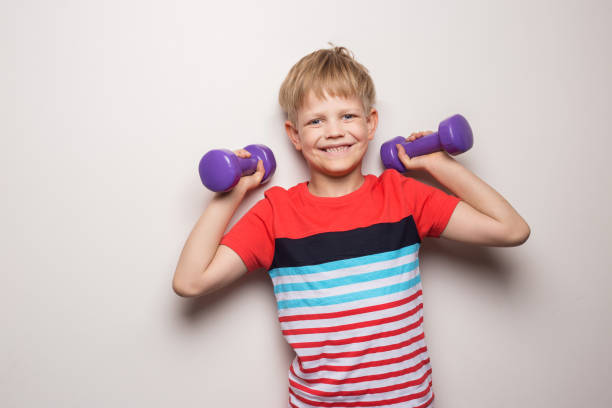 Portrait of a little boy showing his muscles