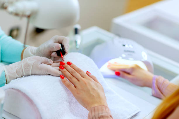 istock Spa customer getting manicure with bright red polish 1145846166