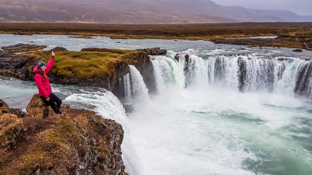 istock Iceland - Girl and a mighty Godafoss 1145847946
