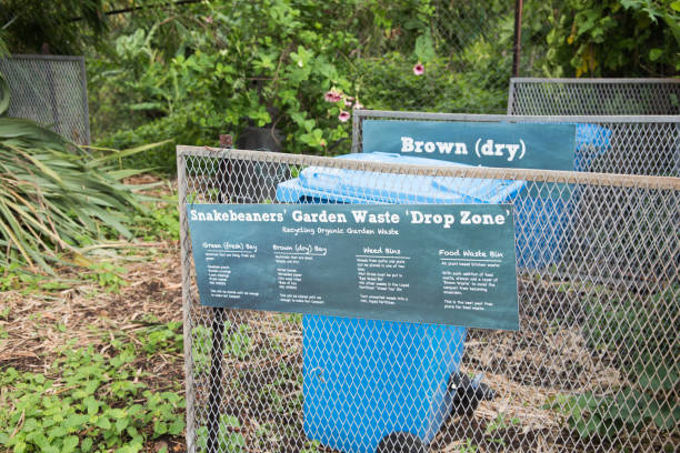 Garden Waste Management Darwin, Northern Territory, Australia-February 1,2019: Green waste drop zone at a ​community garden in tropical Darwin, Australia community garden sign stock pictures, royalty-free photos & images
