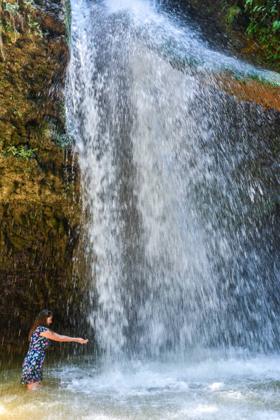 istock Young woman in waterfall. 1145848300
