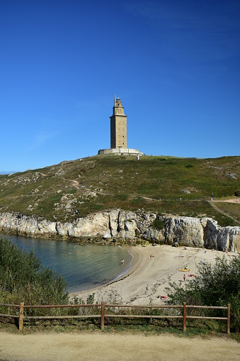Famous roman lighthouse still in use, Torre de Hercules. A Coruña, Spain. View with beach and public park.
