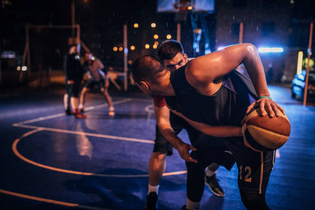 istock Four men playing streetball on a rainy night 1145850315