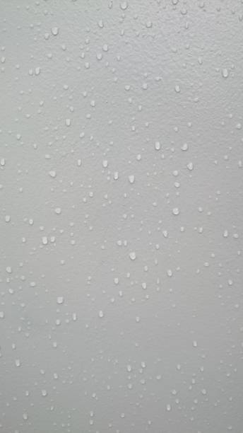 istock drop of water on grey tiles wall texture background 1145850463