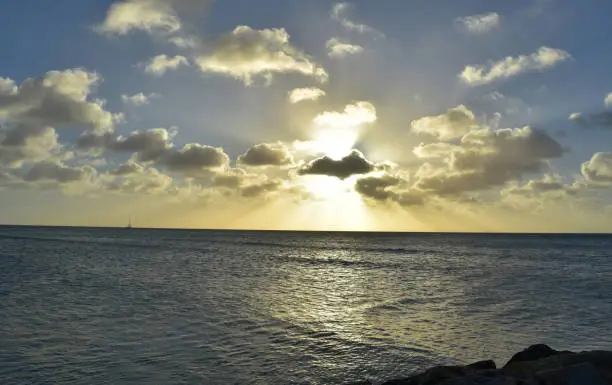 Beautiful sun shining rhough the clouds at dusk in Aruba.