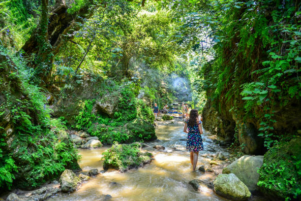 Young woman walking in canyon.