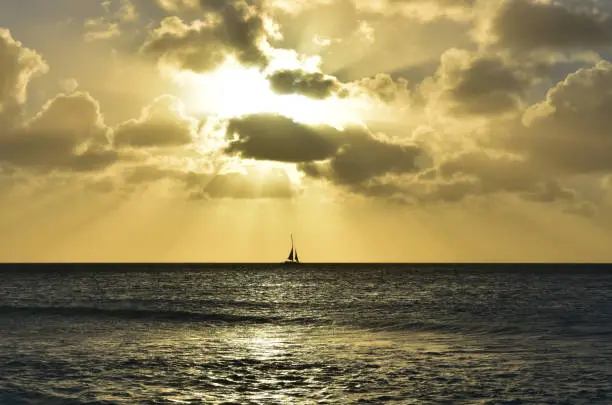 Gorgeous sailboat sailing at sunset in Aruba.