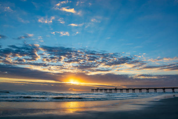 istock Sun rising over horizon and pier in Florida. 1145851041