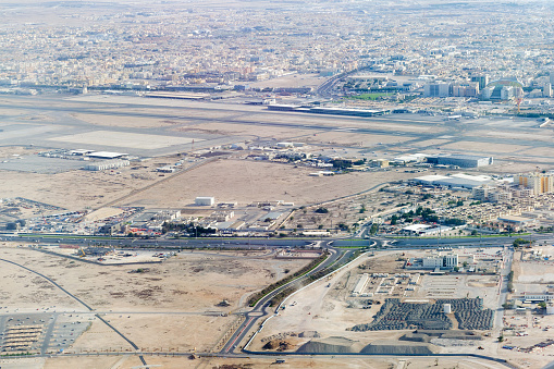 Aerial view at increase of Doha city. Ras Abu Abboud Expy road with F Ring section, part of the Hamad International Airport runway.