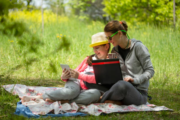 istock Mother and daughter having picnic in the forest 1145852214