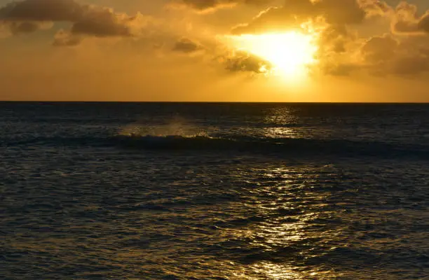 Stunning sunset with crashing waves in Aruba.