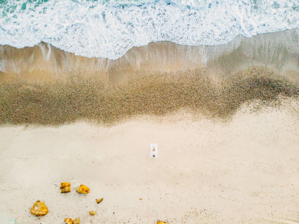 istock Woman sunbathing on the beach 1145854098
