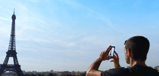 istock Man taking a photograph of Eiffel tower in Paris 1145855716