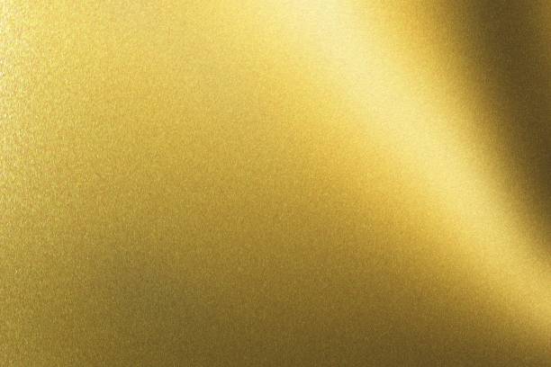 istock Light shining on golden metallic plate in dark room, abstract texture background 1145855808