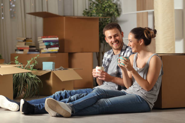 Happy couple moving home resting and talking Happy couple moving home resting and talking tenant stock pictures, royalty-free photos & images