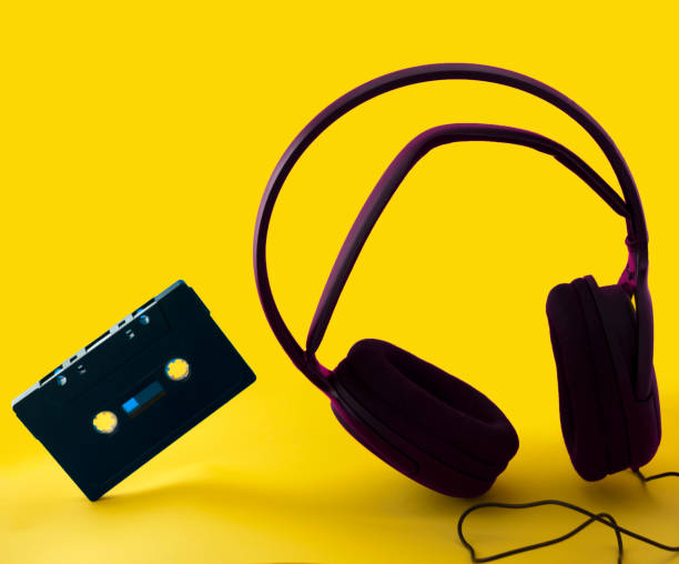 istock headphones and a cassette in a yellow background 1145856023