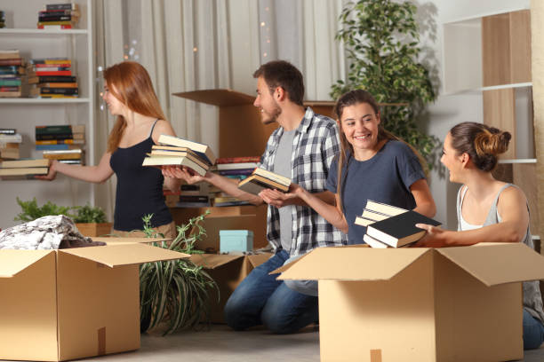 istock Roommates cooperating boxing belingings moving home 1145856052