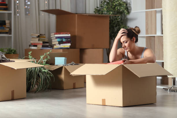Sad evicted tenant moving home boxing belongings Sad evicted tenant moving home boxing belongings belongings stock pictures, royalty-free photos & images