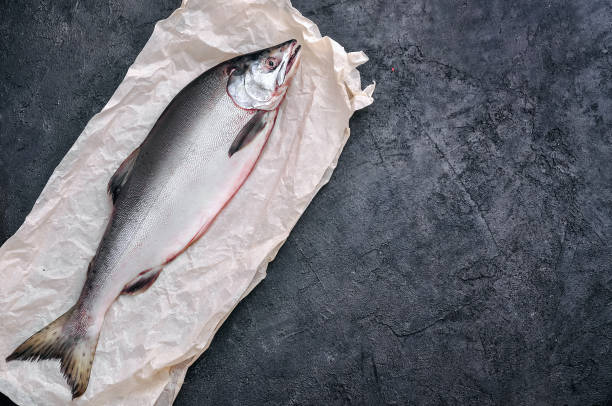 istock Raw Salmon Fish with Spices on Black Stone Background. Top View Flat Lay 1145856896