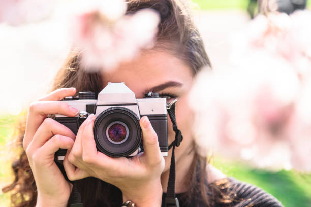 istock Woman taking photo while looking into lens 1145858579