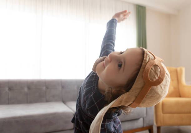 istock Girl playing with toy airplane 1145858949
