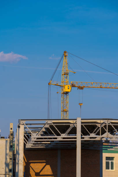 istock building crane and construction site over clear blue sky background 1145859499