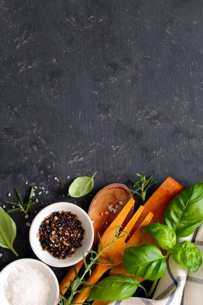 istock Wooden spoon and knife with ingredients on dark background. 1145860957