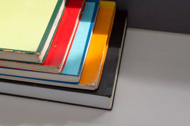 istock Books stacked on the table in library at university in selective focus. 1145862066