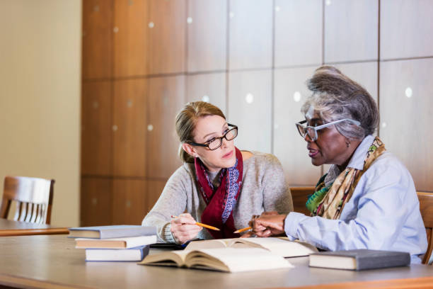 istock Two women doing research in the library together 1145862067