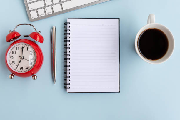 istock Top View of Office Desk With Alarm Clock 1145863332