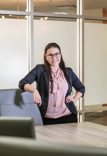 istock Young Hispanic businesswoman standing in office smiling 1145863901