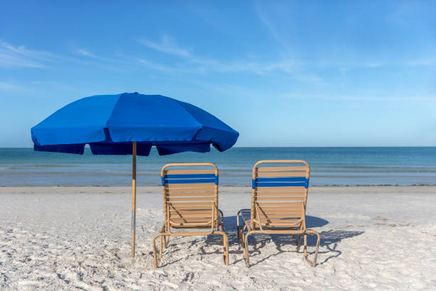 istock Two Beach Chairs with Umbrella on Beach 1145865164